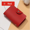 A red premium PU leather ID and credit card wallet lying on a light brown surface.