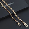 Gold metal chain strap for an adjustable crossbody bag, displayed on a dark box.