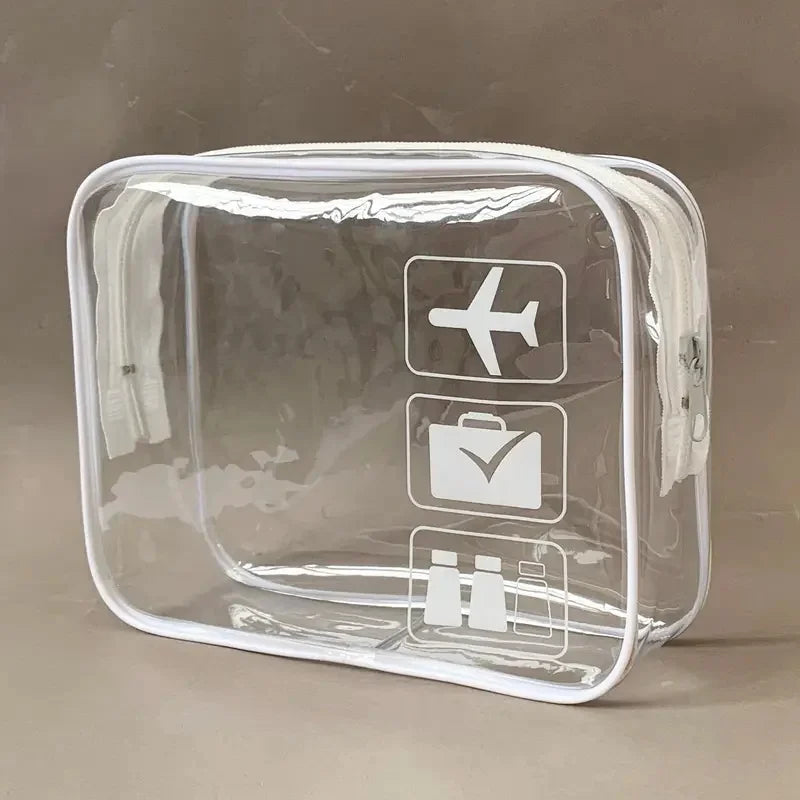 A clear, rectangular plastic toiletry bag with icons for airplane and luggage visible on the front.