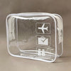 A clear, rectangular plastic toiletry bag with icons for airplane and luggage visible on the front.