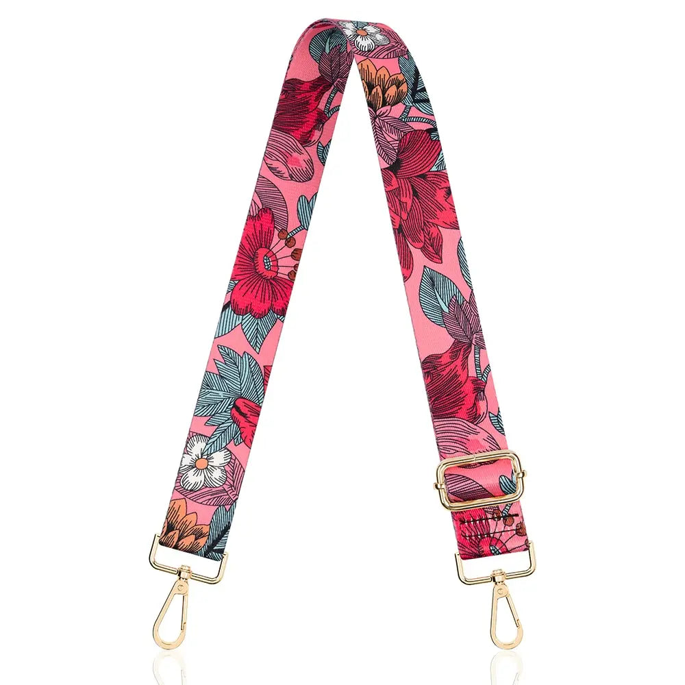 A pink floral patterned nylon crossbody bag strap with gold hardware.