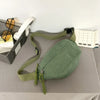 A green corduroy waist pack for women is displayed next to a pair of sunglasses and a notepad.