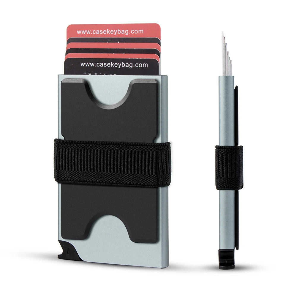 A silver metal pop-up card wallet with a black strap and stacked RFID blocking cards.