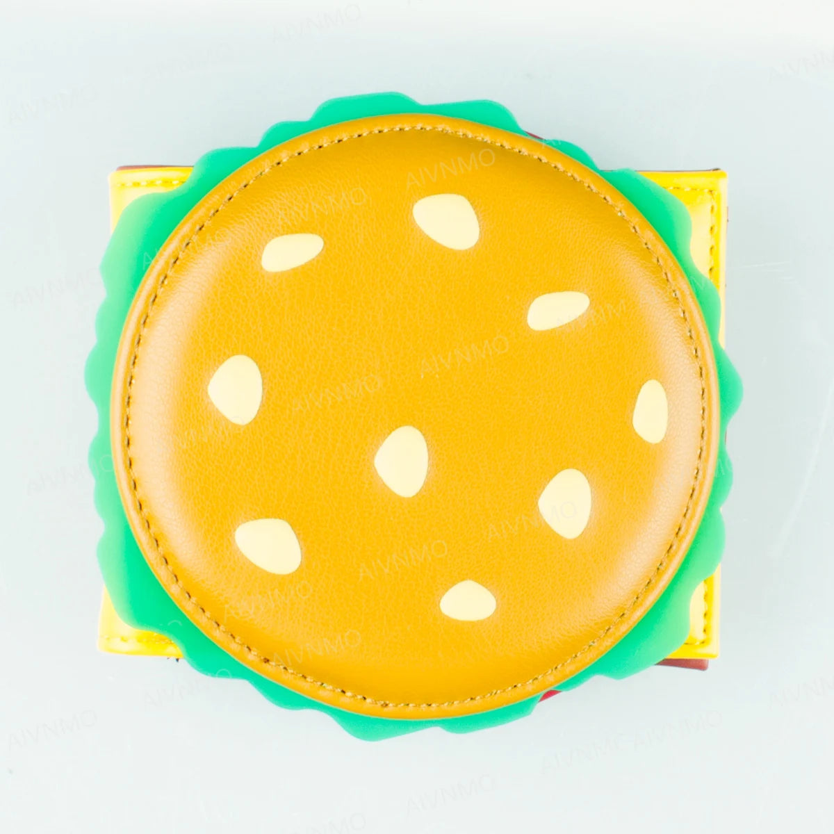 A yellow silicone card holder wallet with a smooth surface and small white dots.