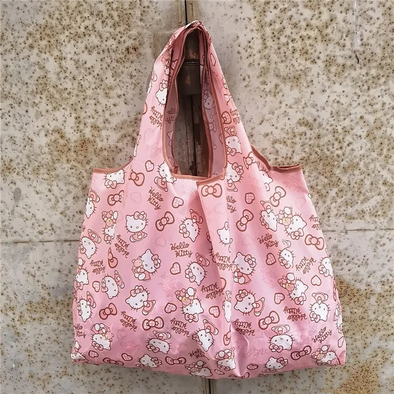 Pink reusable shopping bag with a white pattern featuring cute animal faces