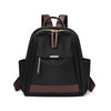 A black nylon travel backpack with brown accents and a zippered top.
