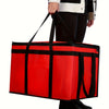 A bright red reusable insulated food delivery bag with black trim being held by a person.