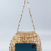 A handmade dumpling bag featuring gold and silver beads, displayed against a light gray background.
