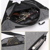 A gray canvas waist fanny bag is shown open, displaying various accessories inside.