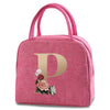 A pink insulated canvas lunch bag with a gold letter P and floral embroidery on the front.