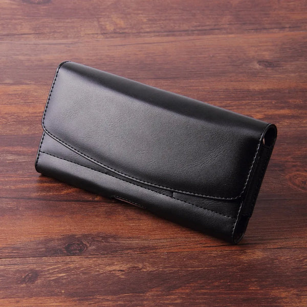 Black leather phone wallet belt clip resting on a dark wooden surface.