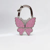 Silver foldable butterfly shaped handbag hook with pink glitter finish