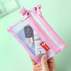 A pink double-layer zipper pouch containing a small electronic device and cards, held in a hand.