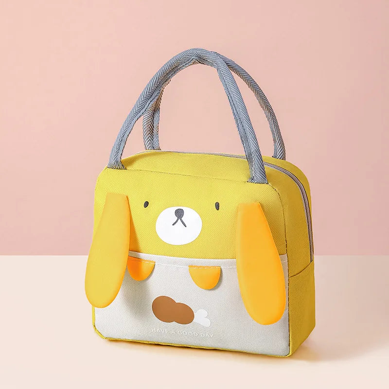 A yellow insulated thermal picnic lunch bag shaped like a dog, featuring light gray straps and a white face.