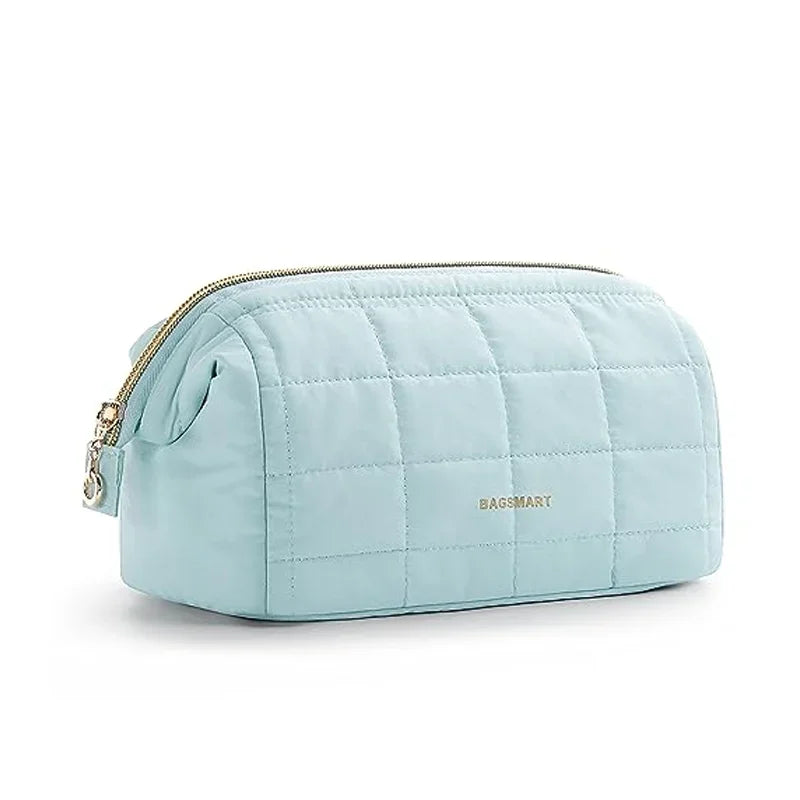 Light blue padded makeup bag with a quilted texture and wide-open design