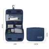 A dark blue portable waterproof toiletry washbag with a hanging hook, shown open and closed.