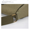 A close-up view of a olive green canvas messenger bag with brass hardware.