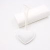 White PU leather heart shaped keychain attached to a white cylindrical object.