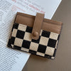 A close-up of a checkered PU leather mini card wallet in brown and black tones.