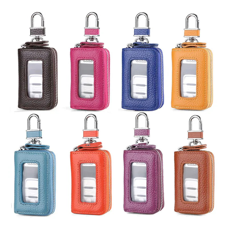 A set of leather car key cases in various colors including black, pink, blue, yellow, and orange with transparent windows.