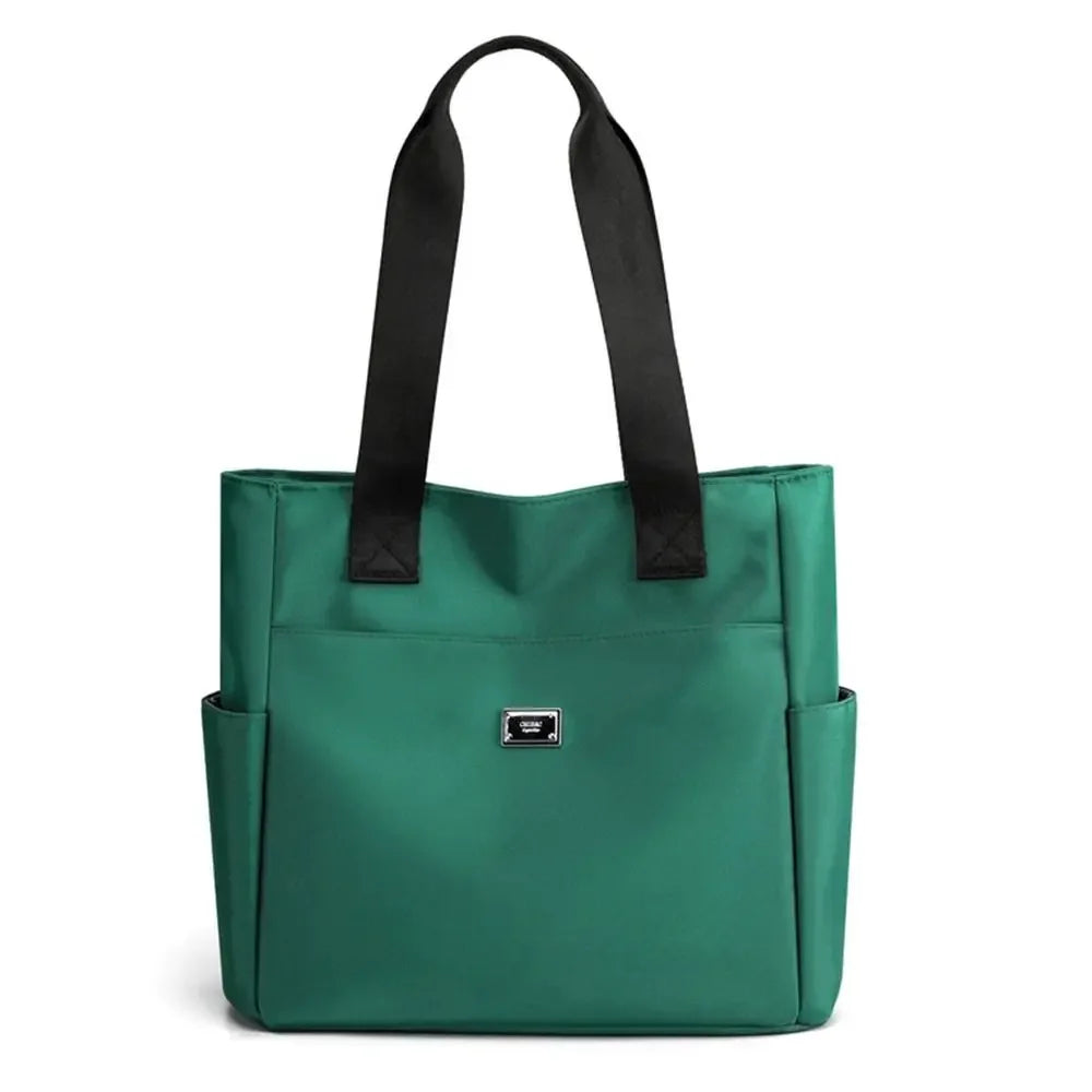 A dark green nylon shoulder tote bag with black straps.