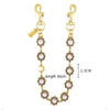 Gold-toned crystal petal keychain with rhinestone charm and a long chain.