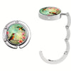 Silver bag hook with two circular, multi-pattern decorative charms featuring birds and flowers