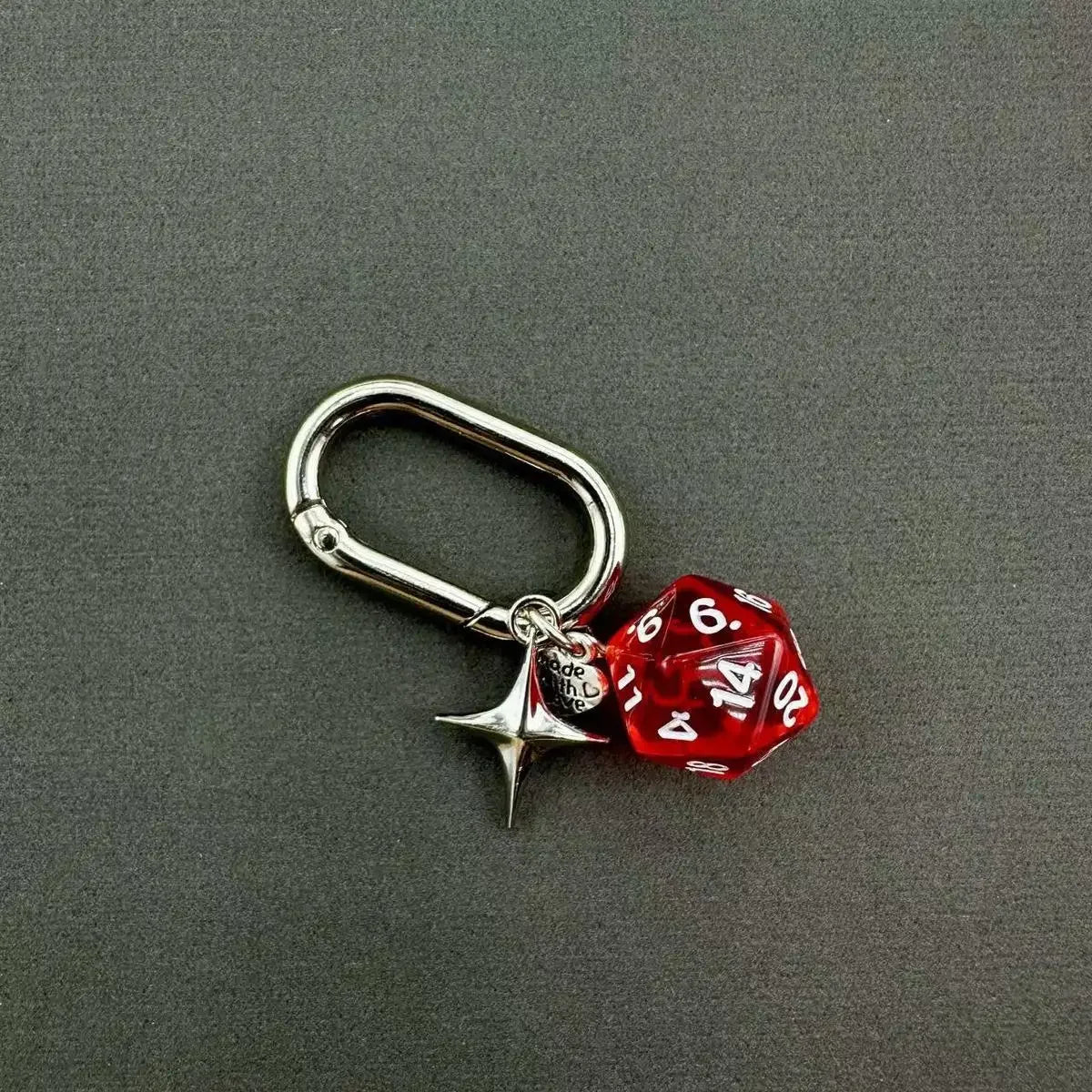 Silver keychain featuring a red resin die with numbers and a small charm