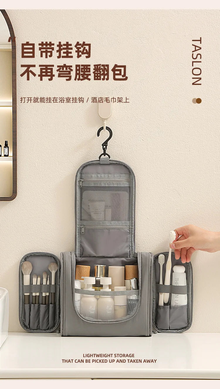 A gray waterproof hanging toiletry bag with compartments for brushes and toiletries is displayed on a white surface.