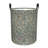 A large, foldable laundry hamper with a beige and green vintage floral pattern.