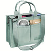 A light mint green canvas tote handbag with leather accents and a mesh fan inside.