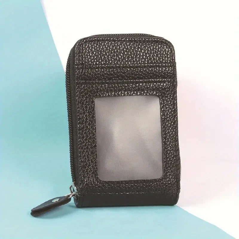 A black textured card holder wallet with a clear window is shown against a light blue background.