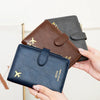 A collection of multi-functional PU leather passport wallets in various shades of pink, green, and brown being held by hands.