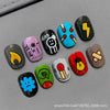 A collection of 30 cute cartoon press-on nails in various colors and designs displayed on a gray surface.