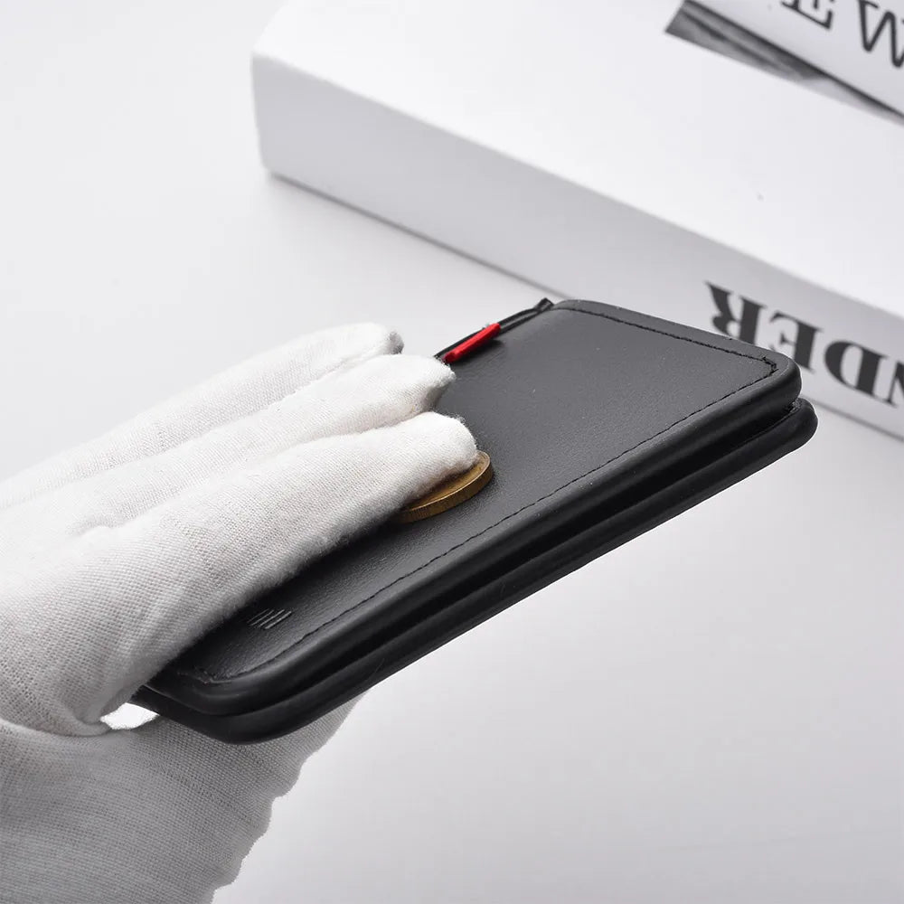 A hand holds a black ultra-thin PU leather credit card wallet with a gold coin inside on a white surface.