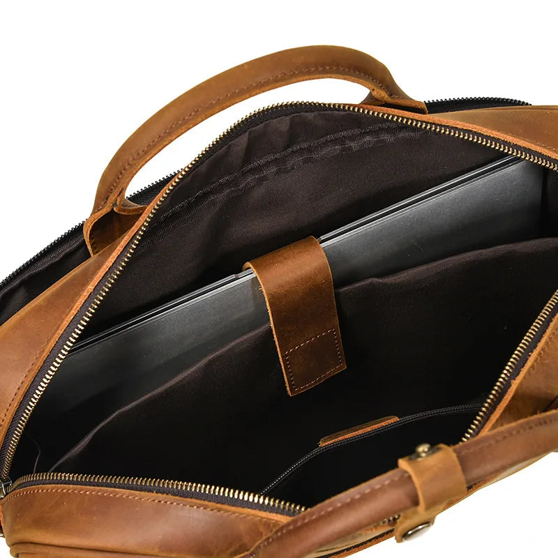 A brown vintage genuine leather briefcase with a zippered compartment and leather handle.