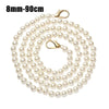 A strand of small white pearls used as a strap for a handbag or purse.