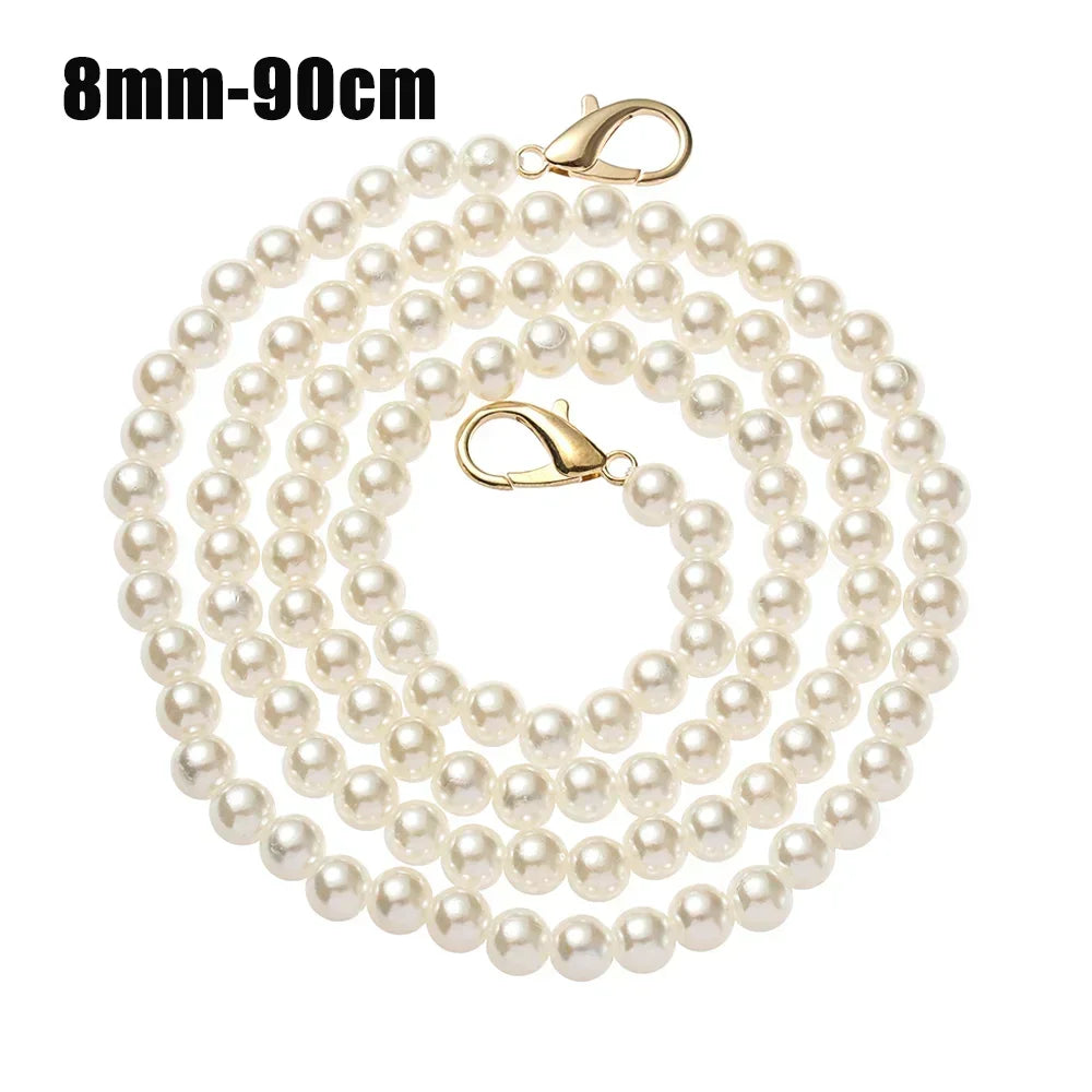 A strand of small white pearls used as a strap for a handbag or purse.