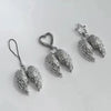 Silver metal angel wing keychain charm with a star detail