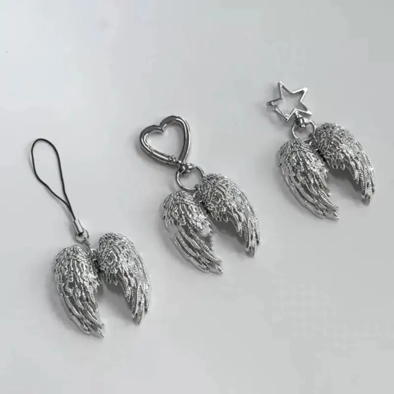 Silver metal angel wing keychain charm with a star detail