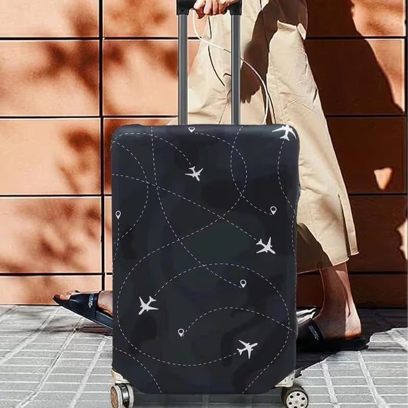 A black airplane pattern luggage protector cover is shown on a rolling suitcase next to a person's leg.