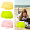A collection of silicone coin pouches in yellow, lime green, and pink, shown both individually and in use on a beach.