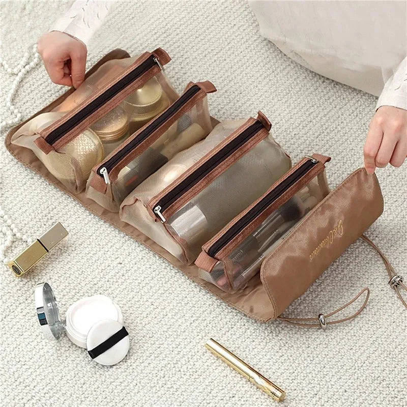 A beige portable detachable makeup bag with a clear window is shown next to cosmetic items on a white knitted surface.