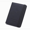 A dark navy passport holder with a leather trim and an airplane emblem.