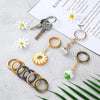 A collection of stainless steel spring clasp keychain rings and carabiner clips with decorative charms on a white background.