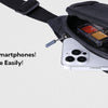 A black nylon waist pack with a strap, showing an open compartment holding a smartphone and accessories.