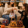 A woman and a child are holding Halloween candy tote bags featuring ghost, bat, and skull designs.