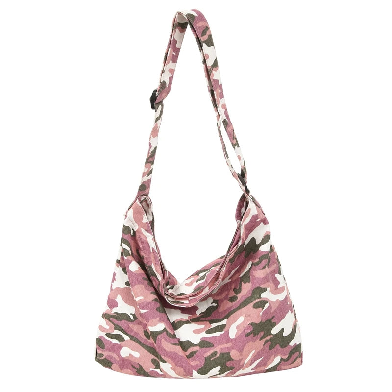 A canvas camouflage shoulder bag with an adjustable strap in pink and green tones.