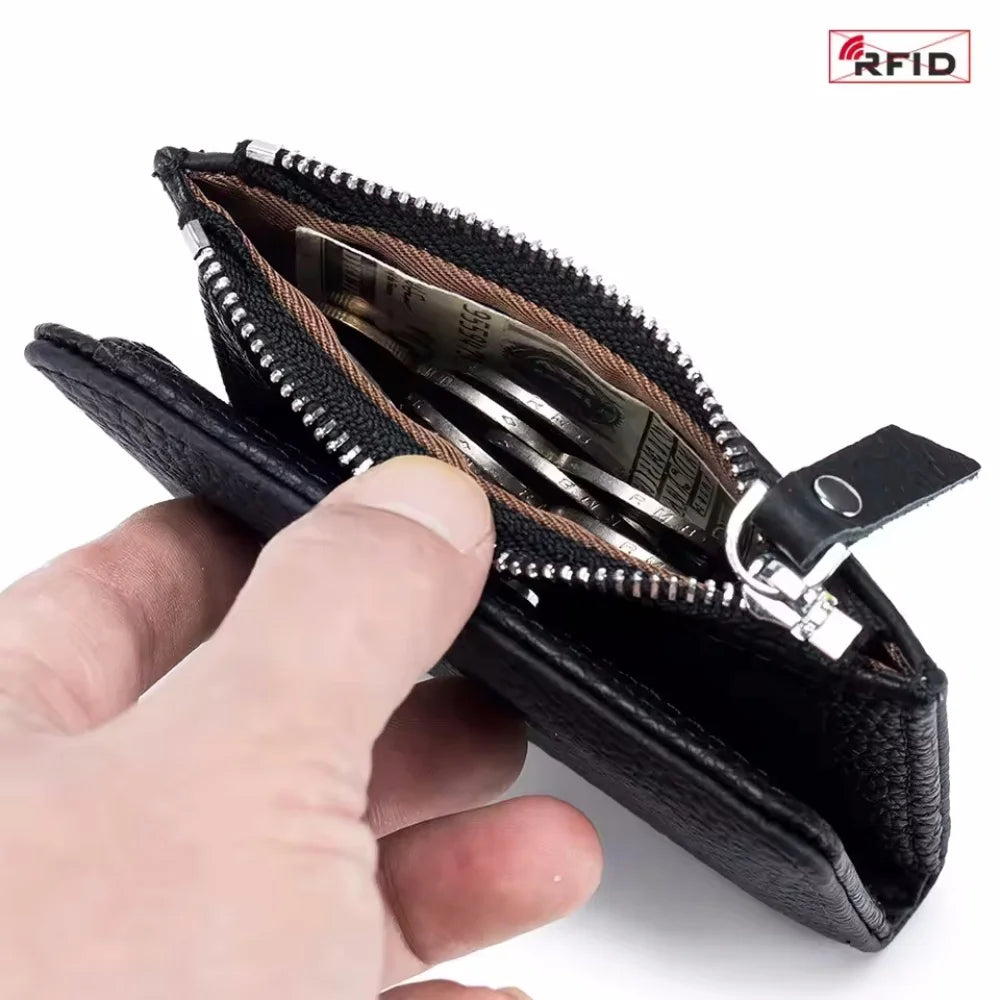 A hand holds an open black genuine leather slim bi-fold wallet displaying several banknotes inside.