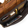 A brown vintage genuine leather briefcase is open, showing various accessories and a smartphone inside.